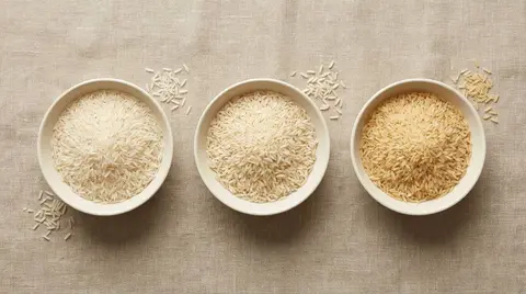 Illustrative overhead comparison of white, steam and golden sella rice in three bowls