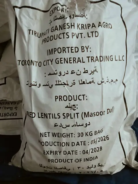 Thirty kilogram woven bag of split red lentils printed with exporter, importer, weight, production and expiry details